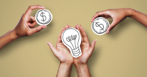 Three hnads holding drawings of coins with $ and a lightbulb