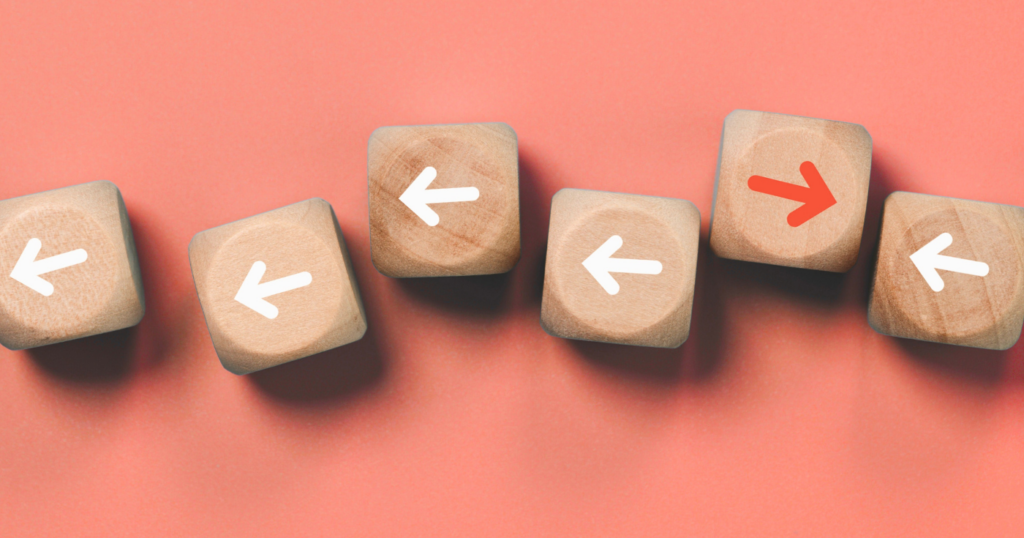 Wooden dice with arrows.