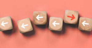 Wooden dice with arrows.