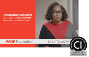 Smiling older woman featured in an AARP Foundation video about their free jobseeker program, with a program award logo in the corner.