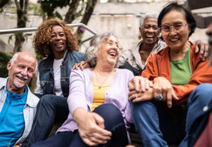A diverse group of older adults laughing and enjoying themselves.